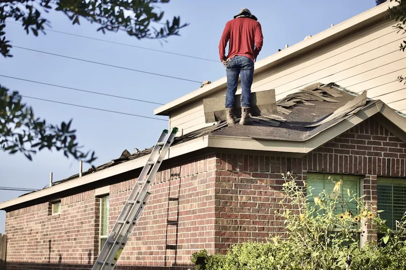 Professional roofer working on a residential roof in Sellersburg